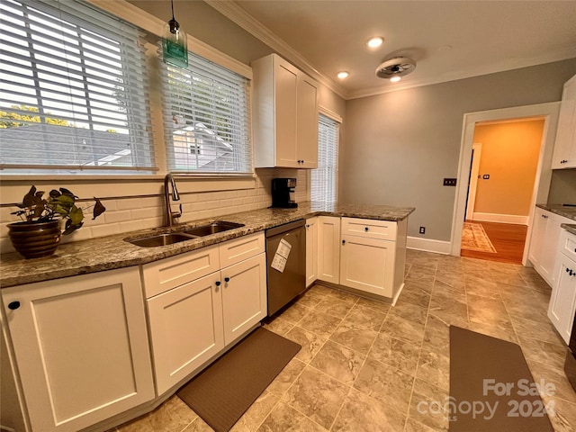 kitchen featuring sink, dishwashing machine, and a healthy amount of sunlight