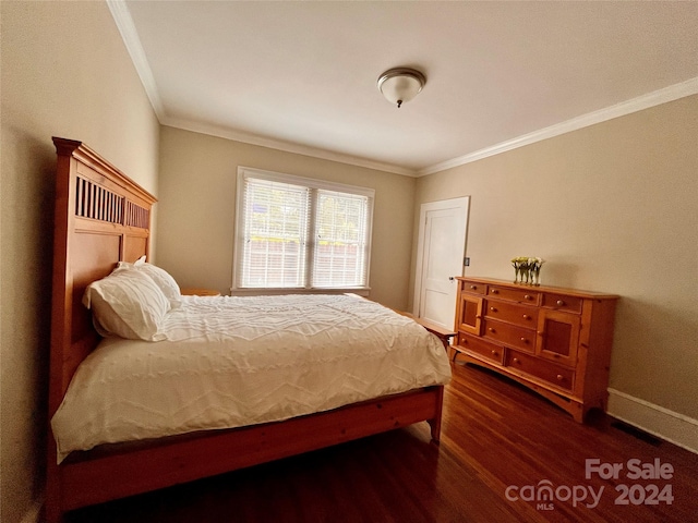 bedroom featuring ornamental molding and dark wood-type flooring