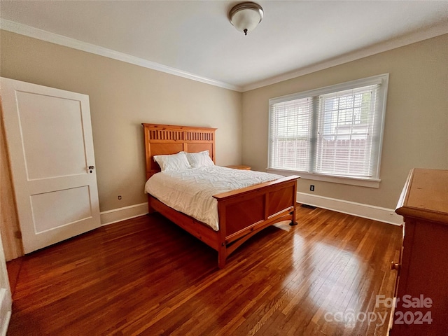 bedroom featuring dark wood-type flooring and ornamental molding