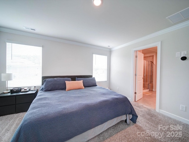 carpeted bedroom with ensuite bath and crown molding