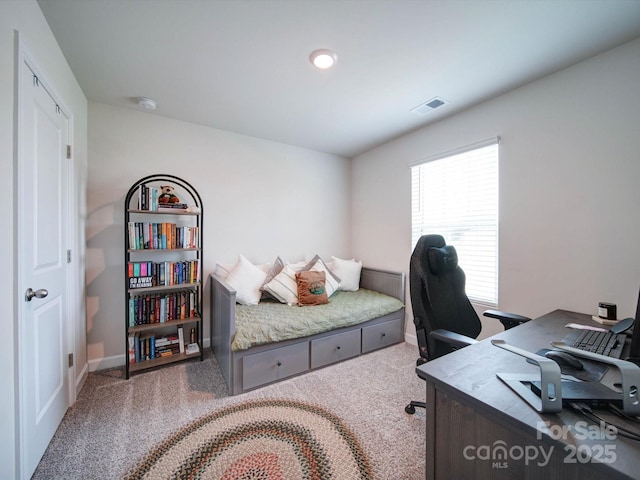 carpeted bedroom featuring multiple windows