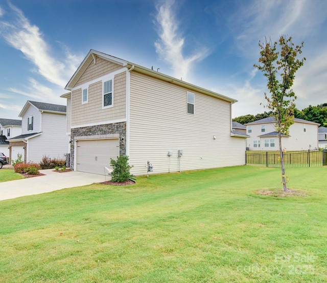 view of side of home with a garage and a yard