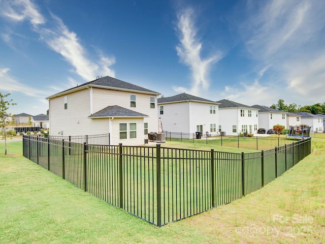 rear view of property with a yard