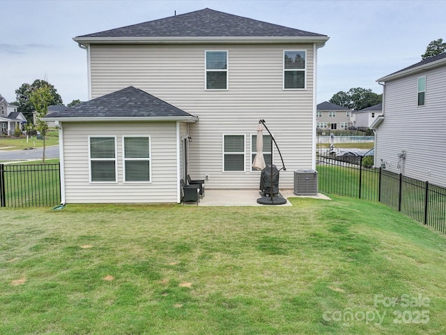 rear view of house with central AC, a yard, and a patio area