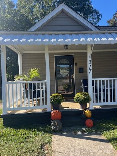 view of exterior entry with a porch