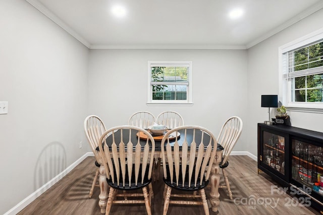 dining room with ornamental molding and hardwood / wood-style floors