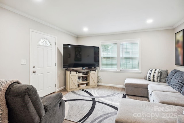 living room featuring hardwood / wood-style flooring and ornamental molding