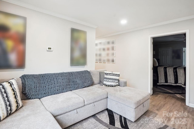 living room with crown molding and hardwood / wood-style flooring