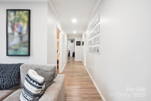 hall featuring light hardwood / wood-style flooring and ornamental molding