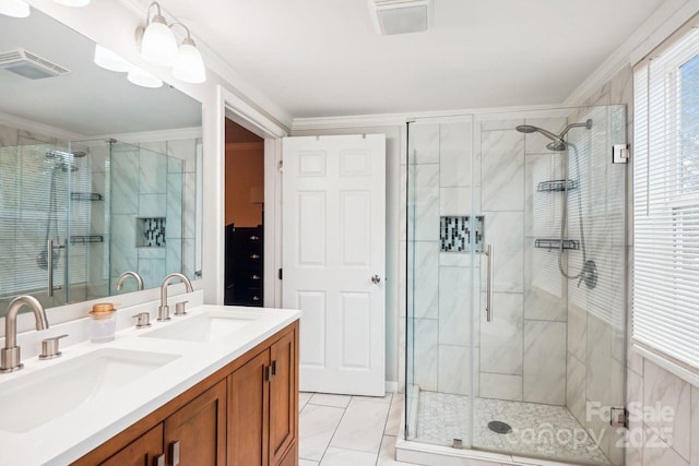 bathroom with ornamental molding, vanity, and walk in shower