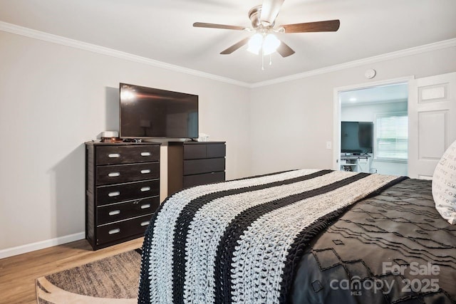 bedroom featuring crown molding, ceiling fan, and light wood-type flooring