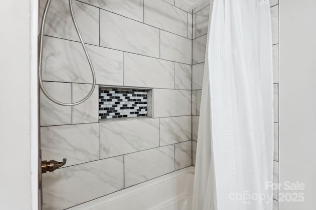 bathroom with shower / bath combo with shower curtain