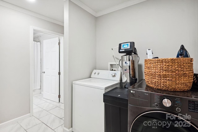 laundry area featuring washing machine and dryer and crown molding