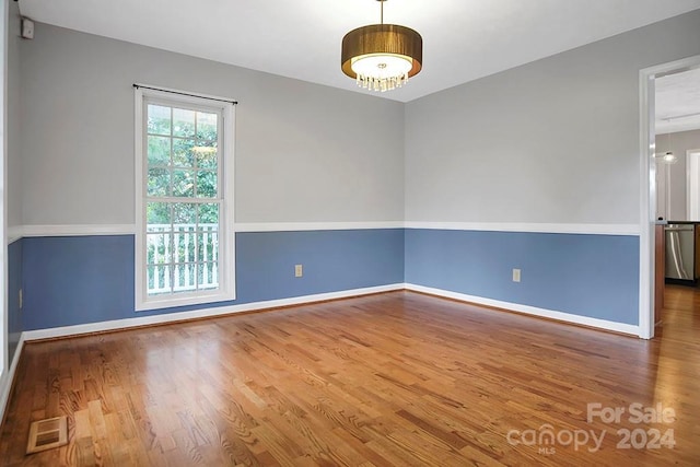 spare room with hardwood / wood-style floors