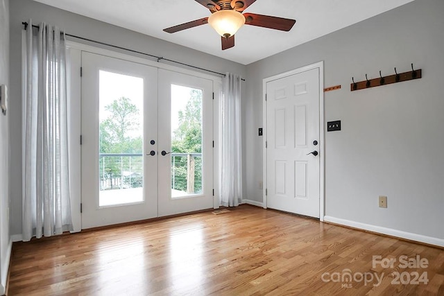 doorway featuring light hardwood / wood-style flooring, ceiling fan, and french doors