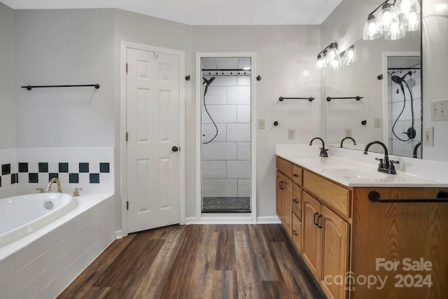 bathroom featuring wood-type flooring, vanity, and independent shower and bath