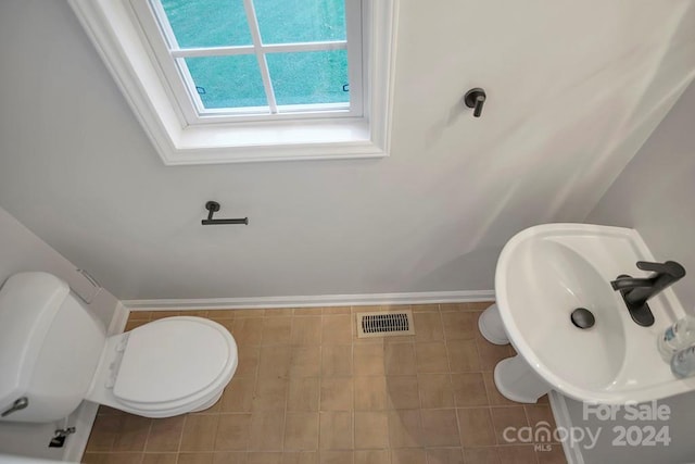 bathroom with tile patterned flooring and toilet