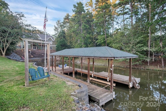 dock area featuring a yard and a water view