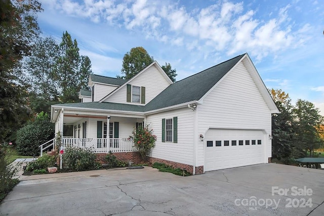 view of property featuring covered porch and a garage