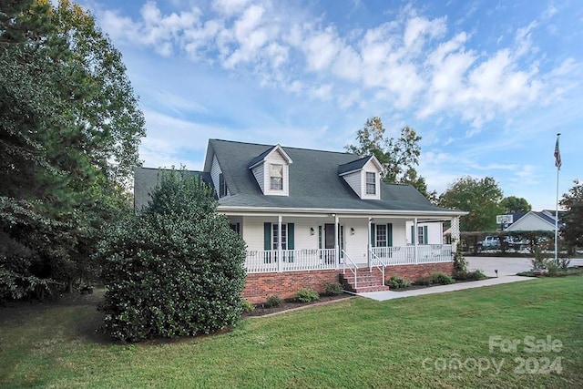 cape cod home with a porch and a front lawn