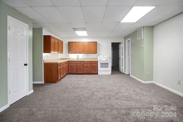 kitchen featuring carpet floors, a drop ceiling, and electric stove