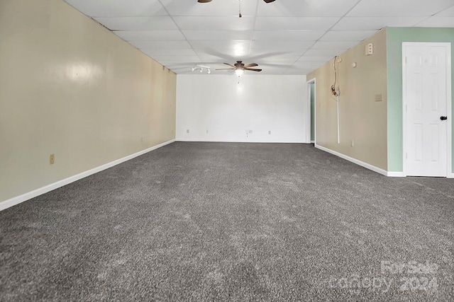 carpeted spare room with a drop ceiling and ceiling fan