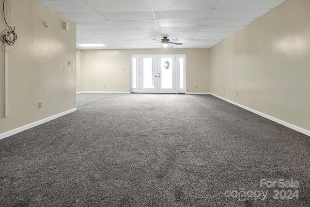 carpeted spare room with ceiling fan, french doors, and a paneled ceiling