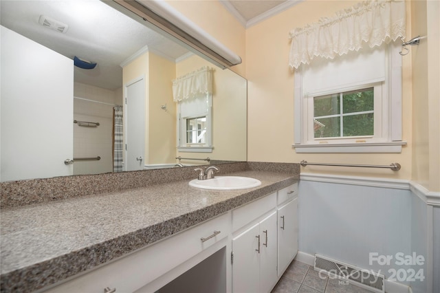 bathroom with walk in shower, vanity, tile patterned flooring, and ornamental molding