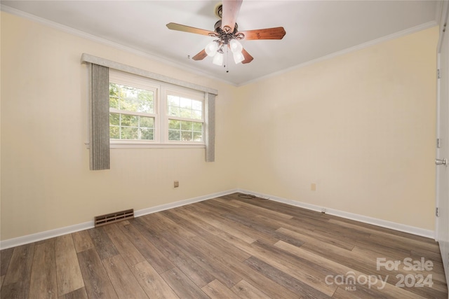 spare room featuring crown molding, hardwood / wood-style floors, and ceiling fan