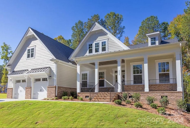 view of front of house with a garage, a front yard, and a porch