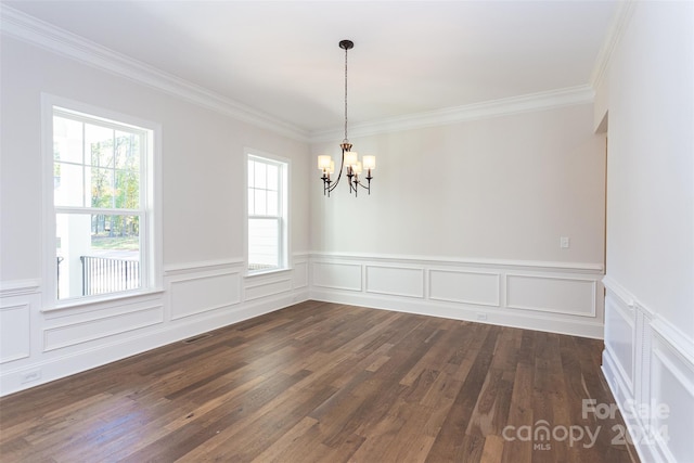 empty room featuring a chandelier, plenty of natural light, and dark hardwood / wood-style flooring