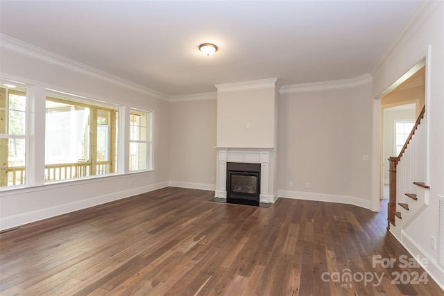 unfurnished living room with ornamental molding and wood-type flooring