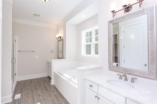 bathroom featuring vanity, hardwood / wood-style flooring, ornamental molding, and plus walk in shower