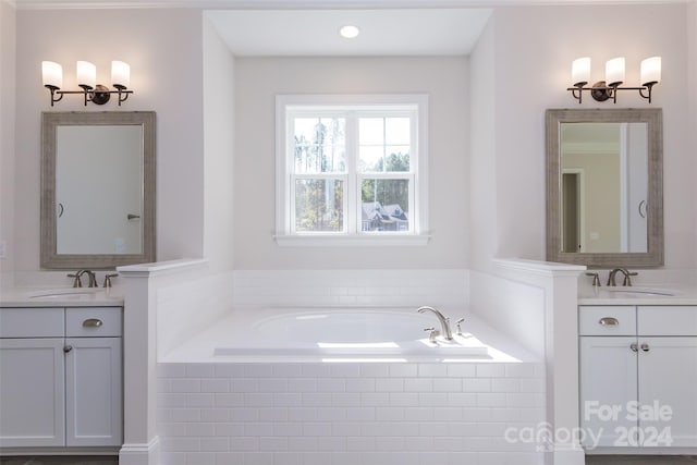 bathroom featuring vanity and a relaxing tiled tub