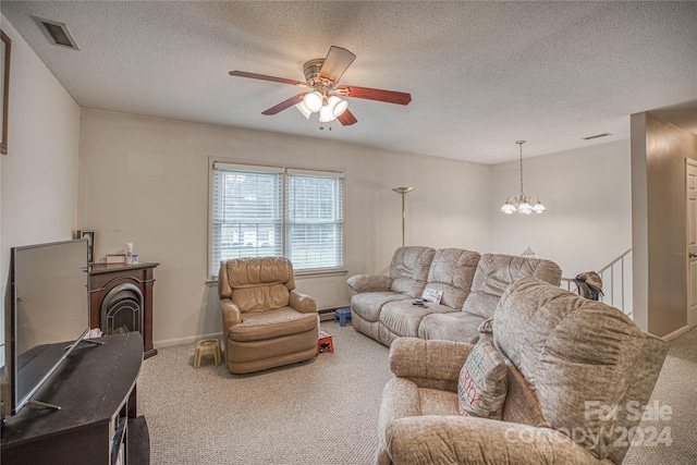 carpeted living room with ceiling fan with notable chandelier and a textured ceiling