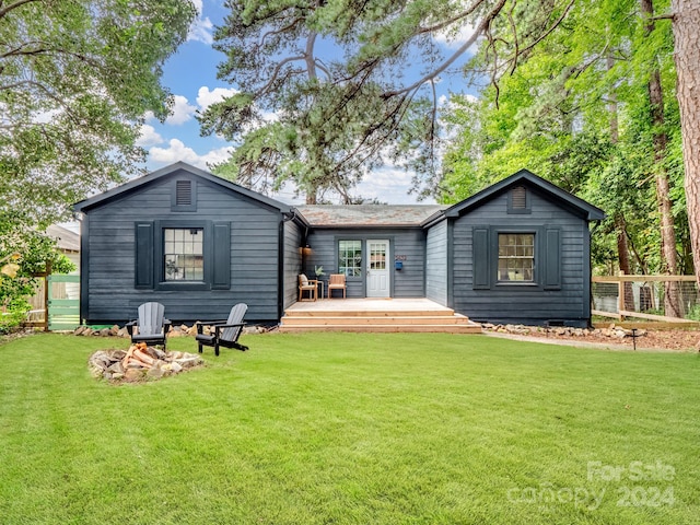 rear view of property with a yard and a wooden deck