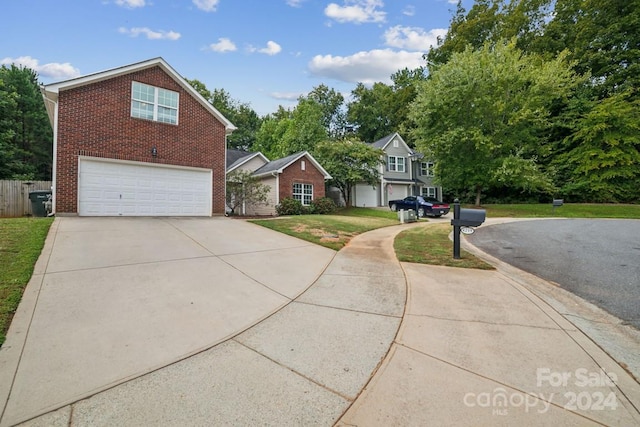 view of front of house featuring a garage and a front lawn