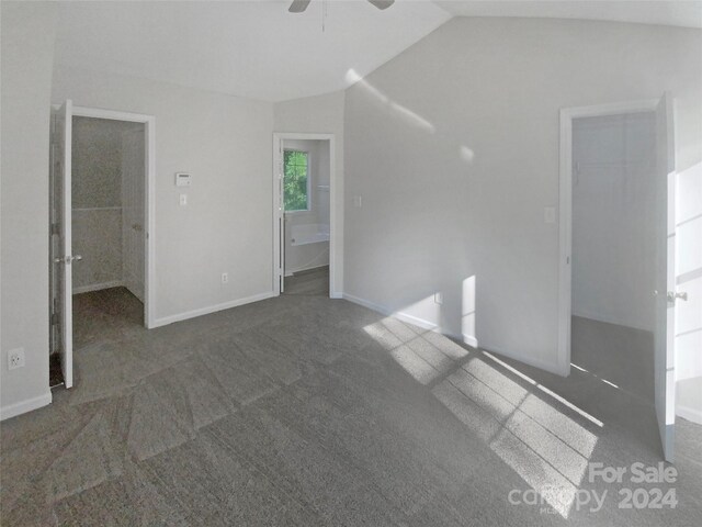 carpeted empty room featuring ceiling fan and vaulted ceiling