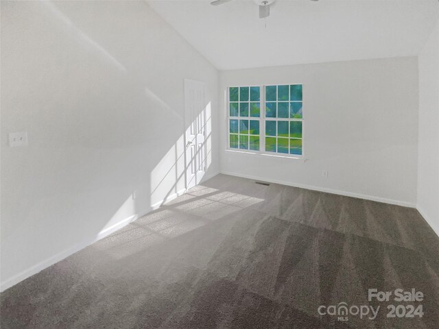 spare room with vaulted ceiling, ceiling fan, and carpet flooring