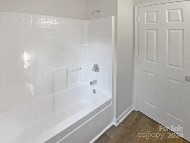 bathroom featuring shower / tub combination and hardwood / wood-style flooring