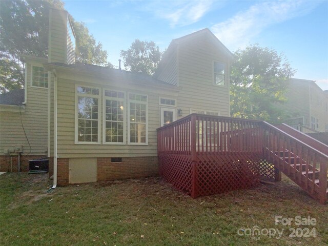 back of house featuring a yard and a wooden deck