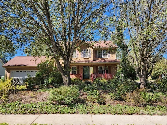 view of front of house featuring a porch and a garage