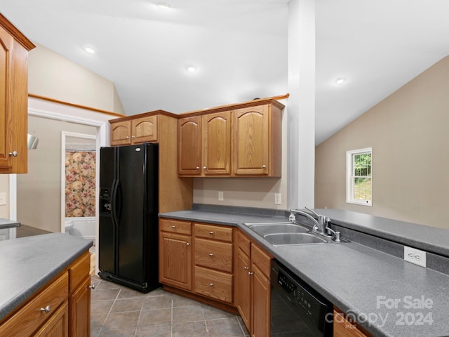 kitchen featuring lofted ceiling, black appliances, sink, and light tile patterned floors