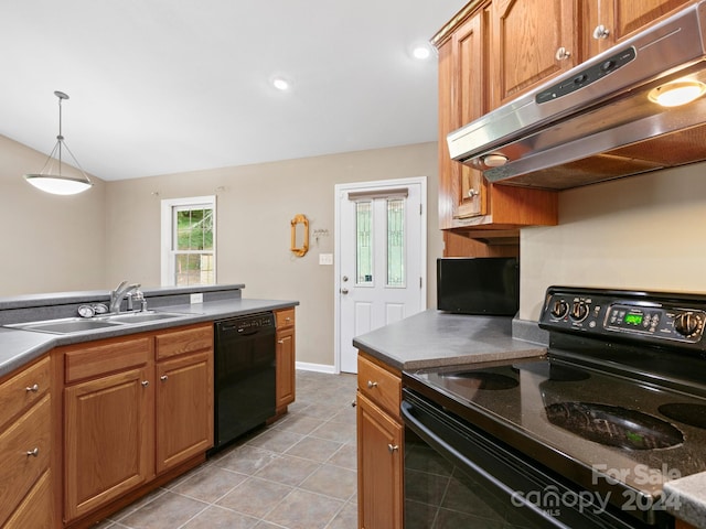 kitchen featuring black appliances, light tile patterned floors, sink, and decorative light fixtures