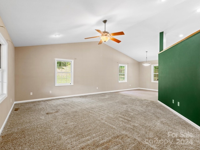 spare room with ceiling fan, light carpet, and vaulted ceiling