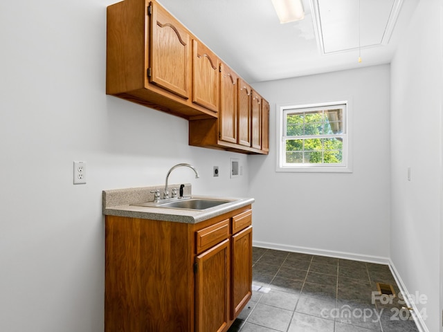 kitchen featuring sink and dark tile patterned floors