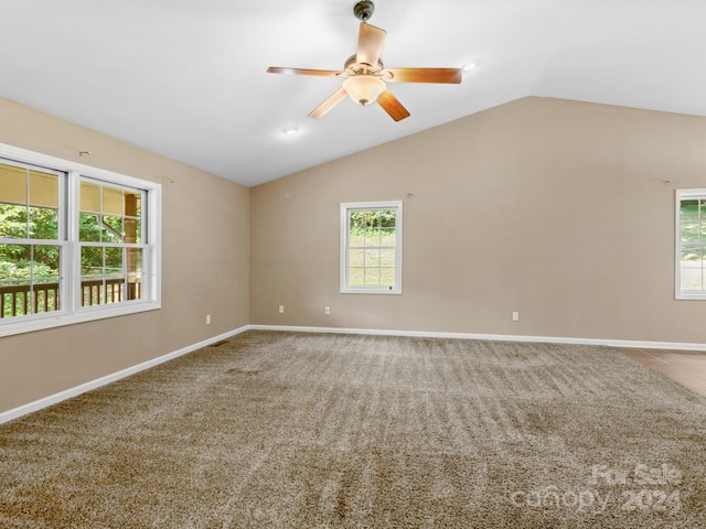 unfurnished room featuring lofted ceiling, ceiling fan, and carpet flooring