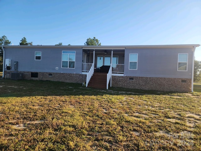 manufactured / mobile home featuring a front lawn and covered porch