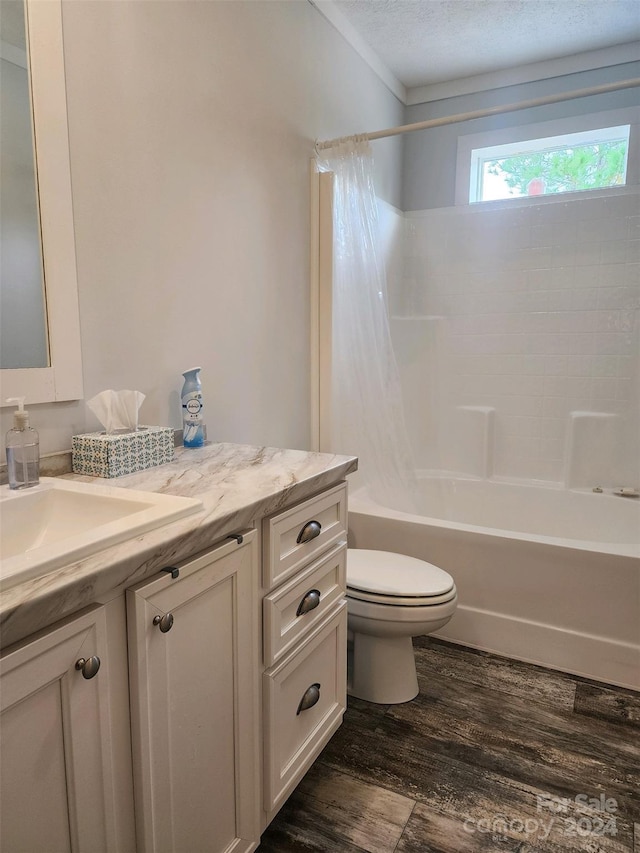 full bathroom with vanity, bathtub / shower combination, toilet, a textured ceiling, and wood-type flooring