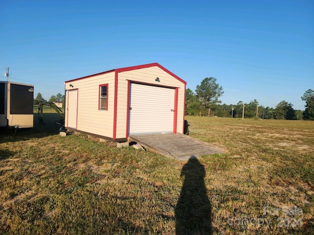 garage featuring a lawn